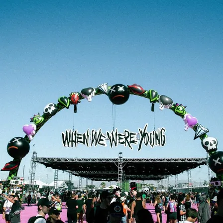 Fans walking under the When We Were Young festival entry arch